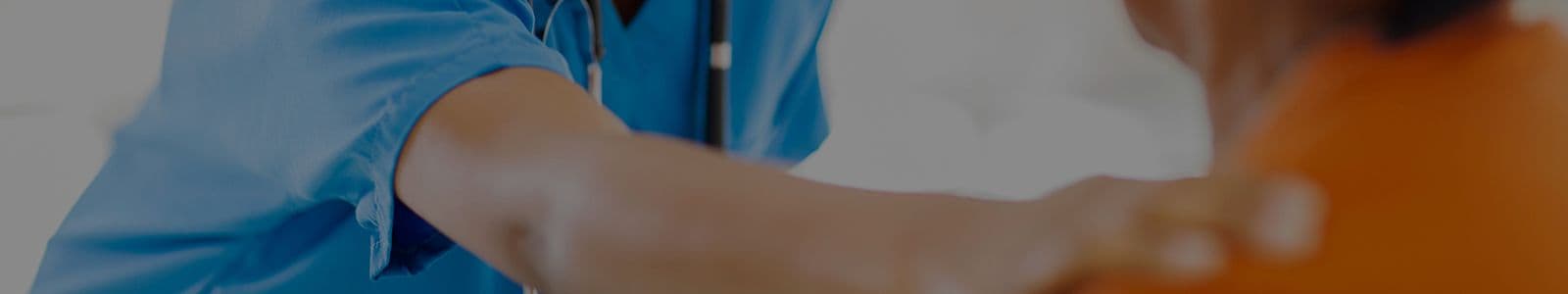 cropped image of a medical professional touching the shoulder of another person